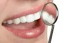 Woman smiling with a mouth mirror