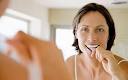 A woman brushing her teeth