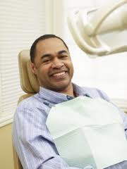 A smiling man in a dental chair
